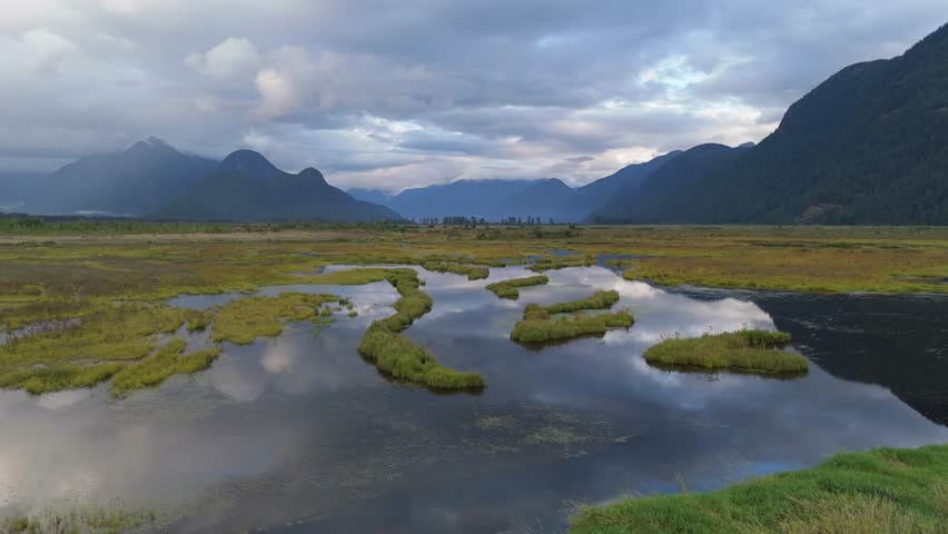 Aerial View of a Serene Wetland Marsh with Mountain Reflections in British Columbia, Canada