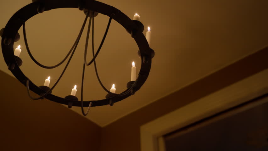 Charming low angle view of white candles in a vintage candelabra