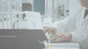 Senior scientist in lab typing on laptop, causing network-user icons and lines mapping data sharing. Technology, innovation, research, analysis, connectivity, data, science - Powered by Shutterstock - Get 15% off with code: PIKWIZARD15