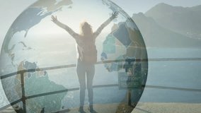 Woman raising arms at sea cliff initiating globe animation showing technology data connection. Adventure, exploration, connectivity, innovation, outdoor, scenic, empowerment - Powered by Shutterstock - Get 15% off with code: PIKWIZARD15