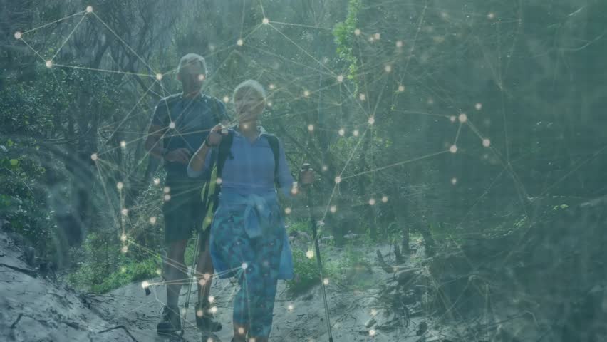 Hiking couple walking forest trail, intensifying network overlay visualizing connectivity data. Adventure, exploration, nature, connectivity, technology, ecosystem, outdoors - Powered by Shutterstock - Get 15% off with code: PIKWIZARD15