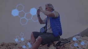 Male hiker lifting smartphone, framing coastline, activating biotech DNA helix and coding overlays. Technology, exploration, adventure, innovation, outdoors, futurism, rugged - Powered by Shutterstock - Get 15% off with code: PIKWIZARD15