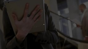 Businesswoman raising tablet by escalator tapping screen and causing animated nodes covering body. Technology, connectivity, innovation, network, digital, communication, futuristic - Powered by Shutterstock - Get 15% off with code: PIKWIZARD15