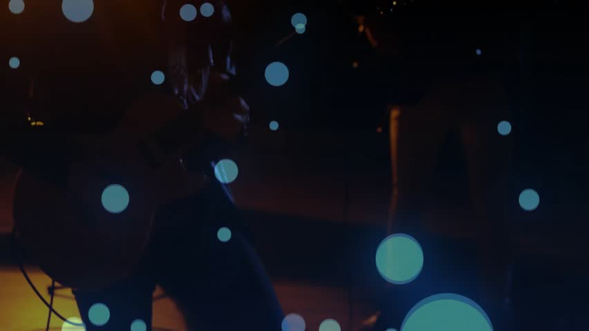 two bandmates tuning instruments and strumming rhythm under warm stage light, drifting blue bubbles. Musicians, performance, ambient, minimalist, artistic, acoustic, creative