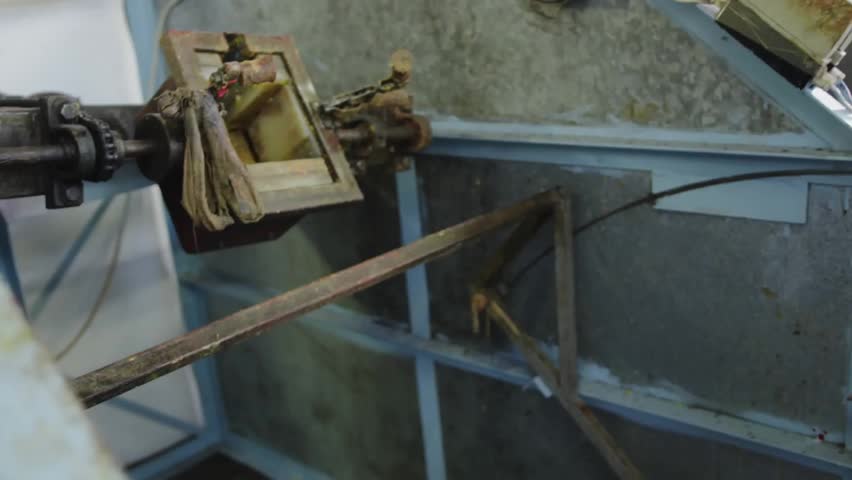 Mechanic gripping frame and pulling rusted part for inspection in maintenance bay with emoji icons. Industrial, machinery, workshop, repair, tools, technician, engineering