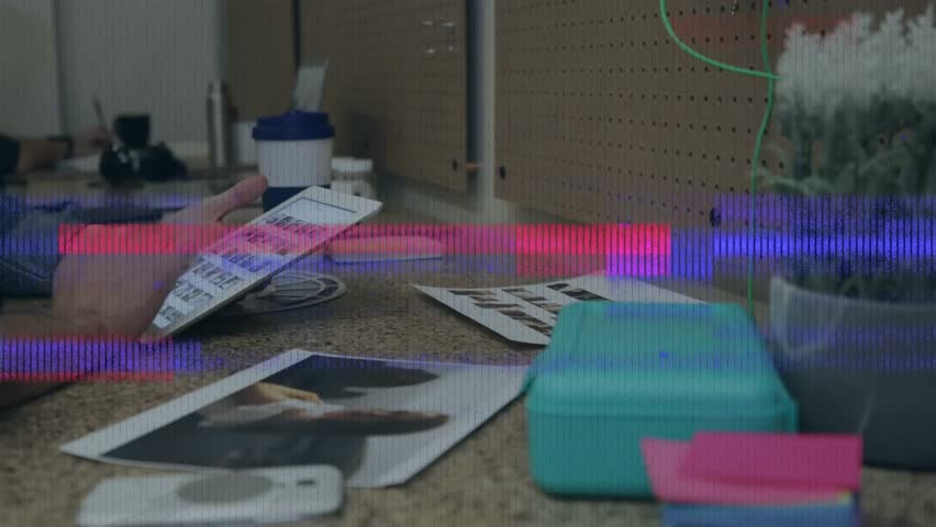 Man flipping sheets triggers tablet swiping and glitch dismissal, reviewing photos in design studio. Collaboration, creativity, technology, arts, workspace, focus, innovation