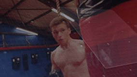 Adolescent male boxer shifting forward and jabbing red punching bag to improve fitness with HUD. Fitness, training, athletic, strength, competition, technology, performance - Powered by Shutterstock - Get 15% off with code: PIKWIZARD15