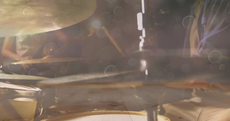 Drummer lifting sticks over hi-hat pedal causing closed hits, open accents crash generating groove. Musician, percussion, rhythm, stage, performance, sound, acoustic