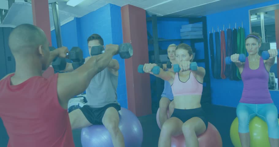 Fitness instructor leading front raises on balls toning shoulders causing pulsing hearts over group. Exercise, group fitness, strength training, wellness, motivation, dynamic, vibrant