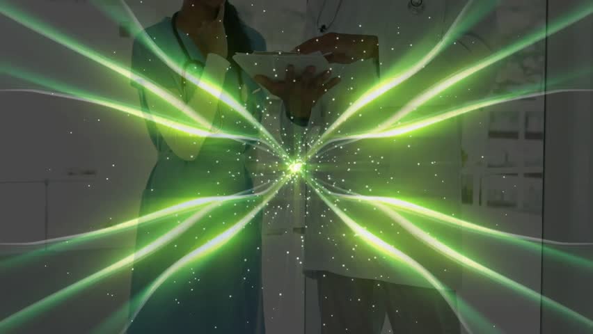 Nurse and doctor tapping tablet in medical hallway, causing pulsing green graphic displaying data. Healthcare, collaboration, technology, medical, communication, diagnostic, innovation - Powered by Shutterstock - Get 15% off with code: PIKWIZARD15