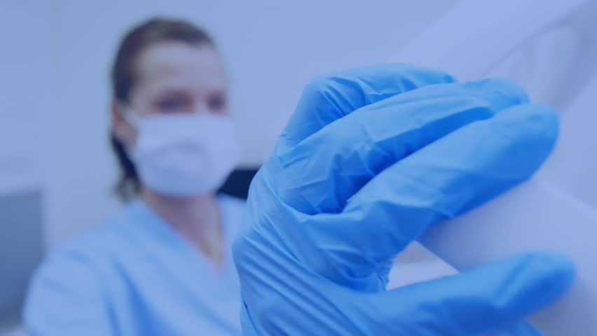 Medical professional holding vial and activating network, lowering mask and showing patient metrics. Healthcare, technology, innovation, analysis, diagnostics, precision, professionalism