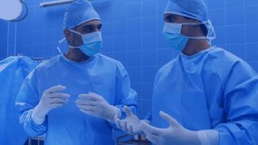 Two surgeons discussing in OR, generating animated icons flooding scene and slowing movements. Medical, healthcare, digital technology, innovation, professionalism, communication, modern - Powered by Shutterstock - Get 15% off with code: PIKWIZARD15