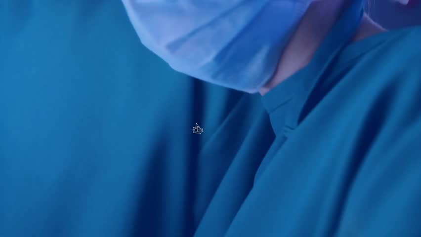 Camera zooming causing hexagon icons animating into medical network around surgeons faces. Medical, technology, innovation, healthcare, team, digital, professional - Powered by Shutterstock - Get 15% off with code: PIKWIZARD15