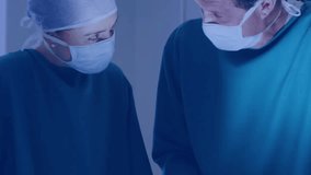 Two surgeons studying surgical field in operating room, social media bubbles appearing then fading. Medical, collaboration, innovation, technology, healthcare, professional, sterile - Powered by Shutterstock - Get 15% off with code: PIKWIZARD15