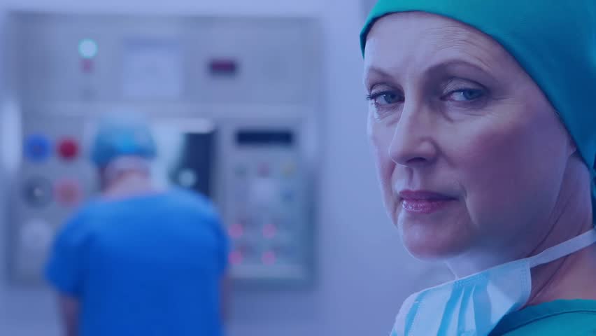 Female surgeon turning head toward camera in operating room creating floating numeric data overlays. Medical, professional, futuristic, innovation, healthcare, technology, analytics - Powered by Shutterstock - Get 15% off with code: PIKWIZARD15