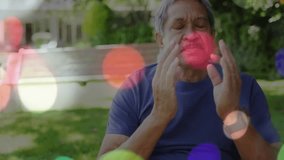 Senior man moving from bench onto grass meditating amid zooming out shot with drifting bokeh. Meditation, serenity, mindfulness, wellness, contemplation, peaceful, nature - Powered by Shutterstock - Get 15% off with code: PIKWIZARD15