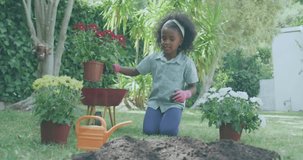 Child picking red flower pot and activating AR tech overlay scanning soil health while planting. Gardening, technology, education, outdoor, innovation, youthful, nature - Powered by Shutterstock - Get 15% off with code: PIKWIZARD15