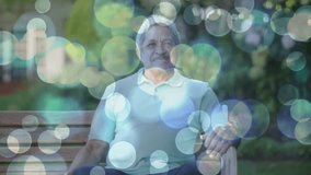 On opening senior man moving hands leaning smiling calm in drifting bokeh lights promoting health. Meditation, serenity, mindfulness, leisurely, rejuvenation, tranquility, contemplative - Powered by Shutterstock - Get 15% off with code: PIKWIZARD15