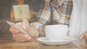 Man tapping smartphone and generating tech data graphs on table while sipping coffee for analysis. Technology, data visualization, digital interface, analytical, modern, workspace, cozy - Powered by Shutterstock - Get 15% off with code: PIKWIZARD15