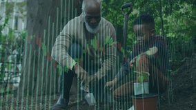 Senior man using trowel and boy lifting seedling from pot and planting sapling in fenced garden. Gardening, family, mentorship, growth, outdoor, connection, rustic - Powered by Shutterstock - Get 15% off with code: PIKWIZARD15