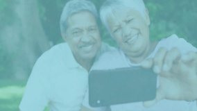 Senior couple extending arm and adjusting smartphone for selfie in social media marketing scene. Vibrant, affectionate, outdoor, candid, natural, lifestyle, cheerful - Powered by Shutterstock - Get 15% off with code: PIKWIZARD15