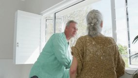 Couple opening shutters, watching social media hearts and thumbs-up icons swirling through window. Senior couple, social engagement, digital interaction, natural light, outdoor view, relaxed - Powered by Shutterstock - Get 15% off with code: PIKWIZARD15