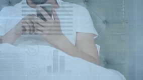 Man reclining, tapping phone screen, raising device for reading with technology data overlays. Technology, digital, relaxation, modern, leisure, interface, communication - Powered by Shutterstock - Get 15% off with code: PIKWIZARD15