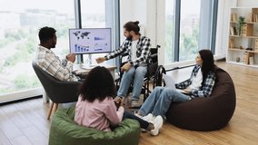 Team of men and women colleagues, mid 20s to early 30s, analyzing business report. Collaboration in modern workspace focusing on inclusiveness, technology, strategy, teamwork, and diversity. - Powered by Shutterstock - Get 15% off with code: PIKWIZARD15