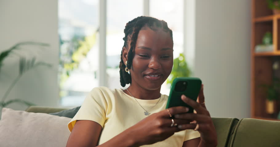 Phone, smile and typing with black woman on sofa in living room of home for post or update. App, browsing and social media with happy African person in apartment for break, communication or me time