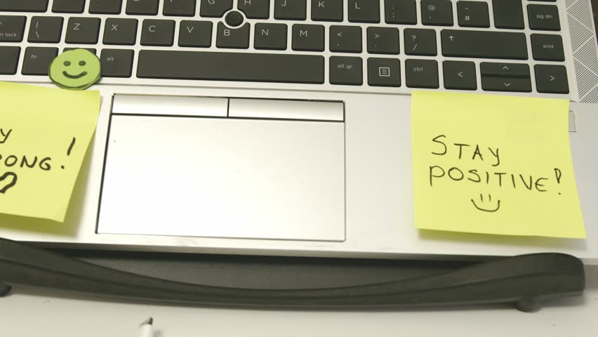 Stay Strong, stay possitive sticky notes on the work laptop. Self Encouragement. High quality 4k footage