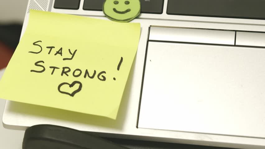Stay Strong, stay possitive sticky notes on the work laptop. Self Encouragement. High quality 4k footage