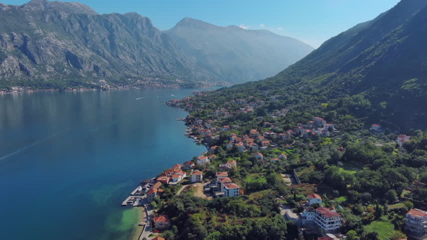 Flying over Kotor bay and small mediterranean town between mountains, Montenegro, 4k