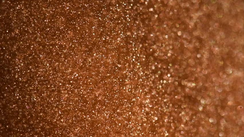 Gold particles floating background, magic dust, Liquid gold, golden abstract backdrop. Golden abstract backdrop. Beautiful metallic yellow texture, paint close-up. Art Wallpaper surface 