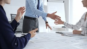 Business partnership success concept with handshake in modern office, financial charts, graphs and laptop on desk representing teamwork, agreement and corporate growth - Powered by Shutterstock - Get 15% off with code: PIKWIZARD15