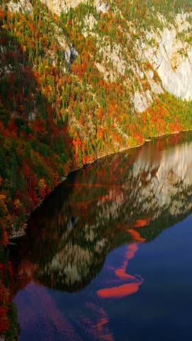 Autumn landscape reflection in serene lake and vibrant foliage