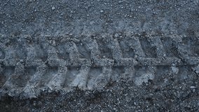 Top down view of a vehicle car or heavy machinery tire or wheel tracks in gravel and sandy gray colored ground at day time.  - Powered by Shutterstock - Get 15% off with code: PIKWIZARD15
