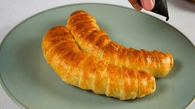 Pastry chef drizzling chocolate croissants with bananas cooking on kitchen. Woman preparing fresh fruit dessert at home. Cuisine culinary cook bake domestic food sweets treats, recipe ingredient. - Powered by Shutterstock - Get 15% off with code: PIKWIZARD15