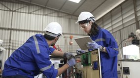Blue collar workers at machine shop with welding robot arm. Factory and machinery. - Powered by Shutterstock - Get 15% off with code: PIKWIZARD15