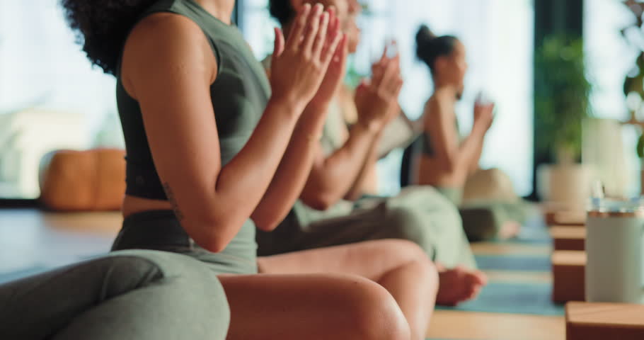 Yoga class, meditation and hands with mudra in studio, relaxation and holistic healing in zen practice. Wellness, mind body connection and people at retreat for mindfulness, thinking and awareness.