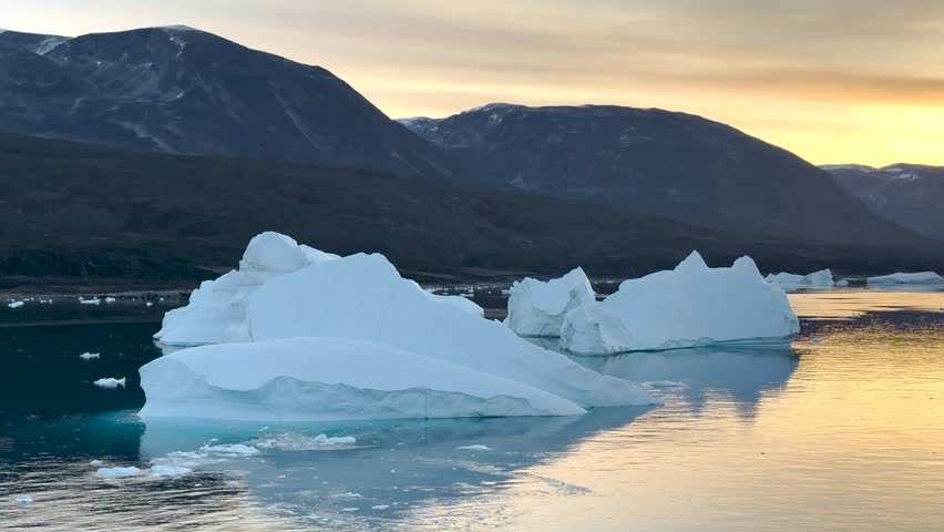 Stunning sunset over icy waters with floating icebergs in Greenland