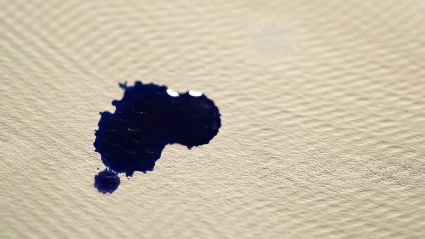 Blue ink splashes on a grunge paper background