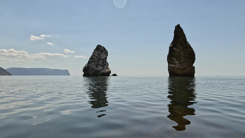 Sea rocks ocean, calm water reflections, tranquil natural seascape
