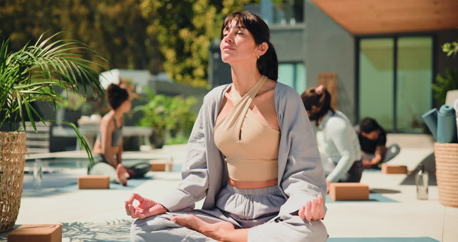 Face, yoga class or happy woman outdoor with instructor for breathing, health or fitness. Mature teacher, yogi or portrait of person with smile for holistic exercise, peace or meditation for wellness