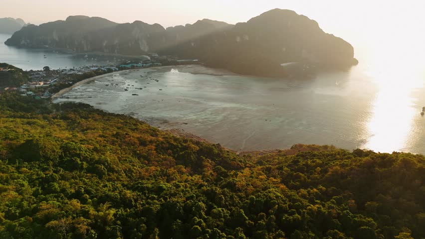 Golden sunset illuminate phi phi islands, Krabi and Phuket, Thailand, revealing lush tropical vegetation and turquoise waters