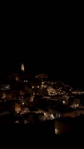 the city of Matera, Italy, at night. Matera is famous for its ancient cave dwellings, known as the "Sassi," which are carved into the rock of the Murgia plateau. April 26, 2023