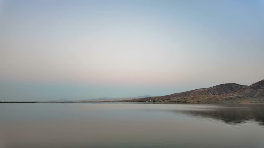 Dusk Clouds Passing Over a Serene Lake, 4K Timelapse.