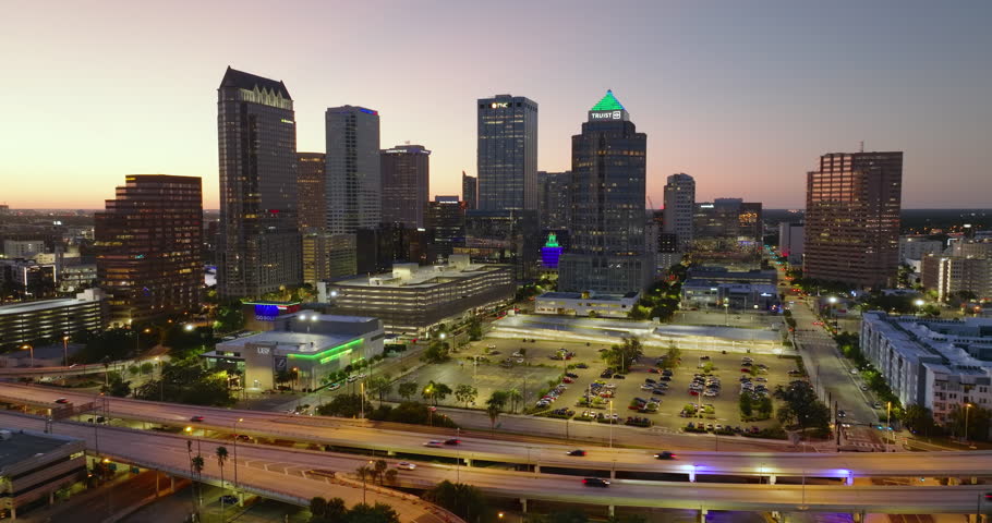 Downtown district of Tampa city in Florida, USA after sunset. Brightly illuminated highway and high buildings in modern American urban area.