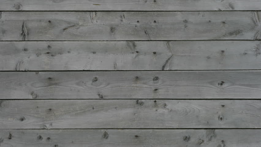 Animation of pan down from real grey wood to three illustrated apples. Apples coming into focus and wood going out of focus. Slight zoom in after pan in complete.