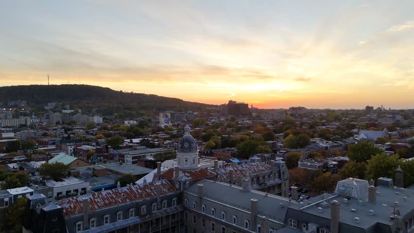 Aerial view of Montreal skyline with domed church tower against cityscape. g.