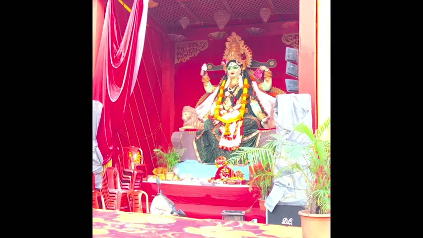 Colorful and intricately designed Durga Puja pandal with a large idol of Goddess Durga ,The scene depicts traditional Navratri festival celebrated in India, cultural and religious significance.